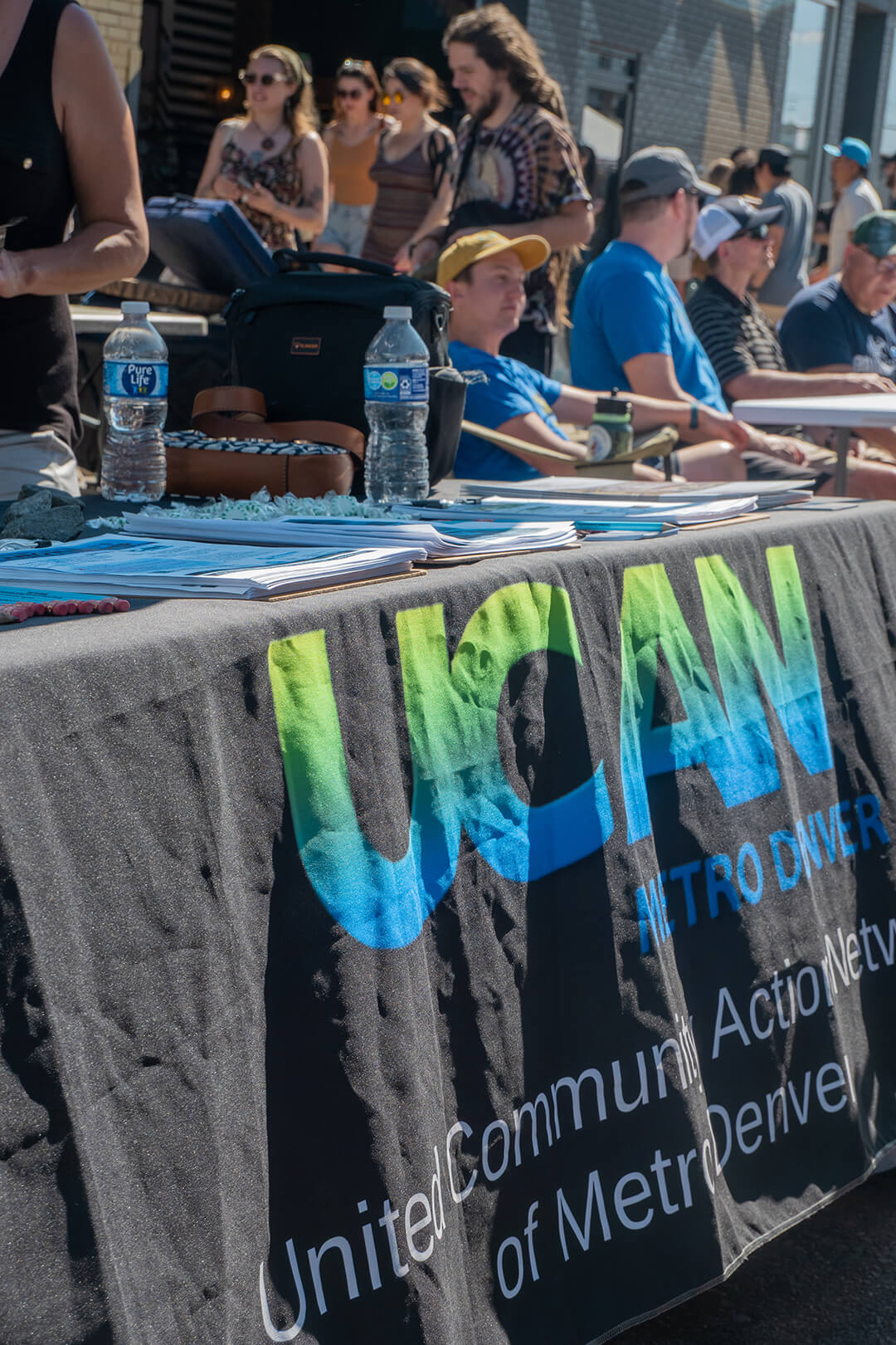 UCAN table with branded table cloth set up outdoors in Denver during a block party