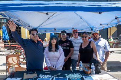 UCAN volunteer in front of crowd giving seminar on home ownership and financial literacy in Denver, CO